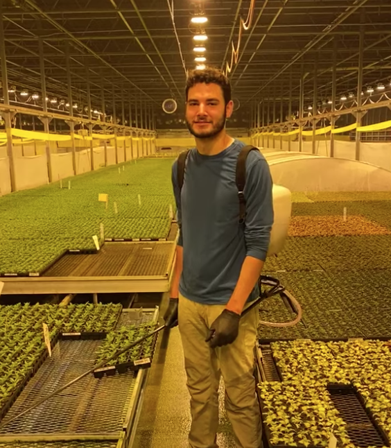student in greenhouse