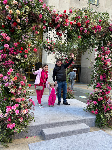 family under arch floral display