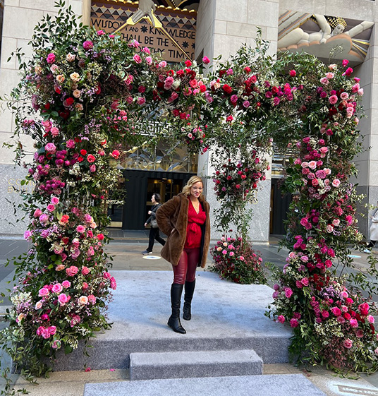 woman under floral arch