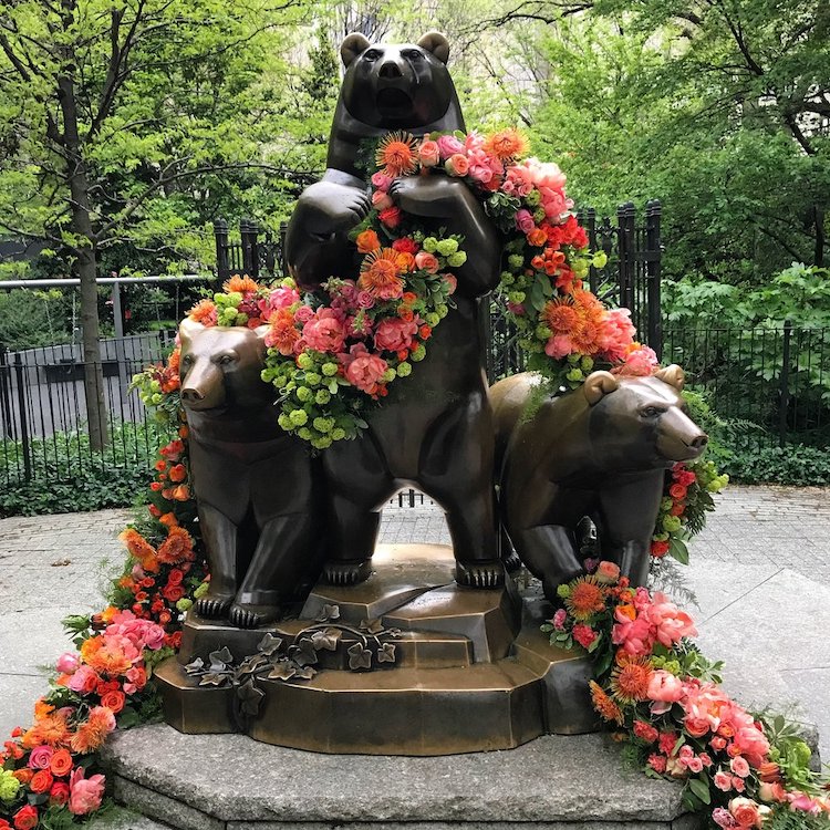 bear statue with flower garland