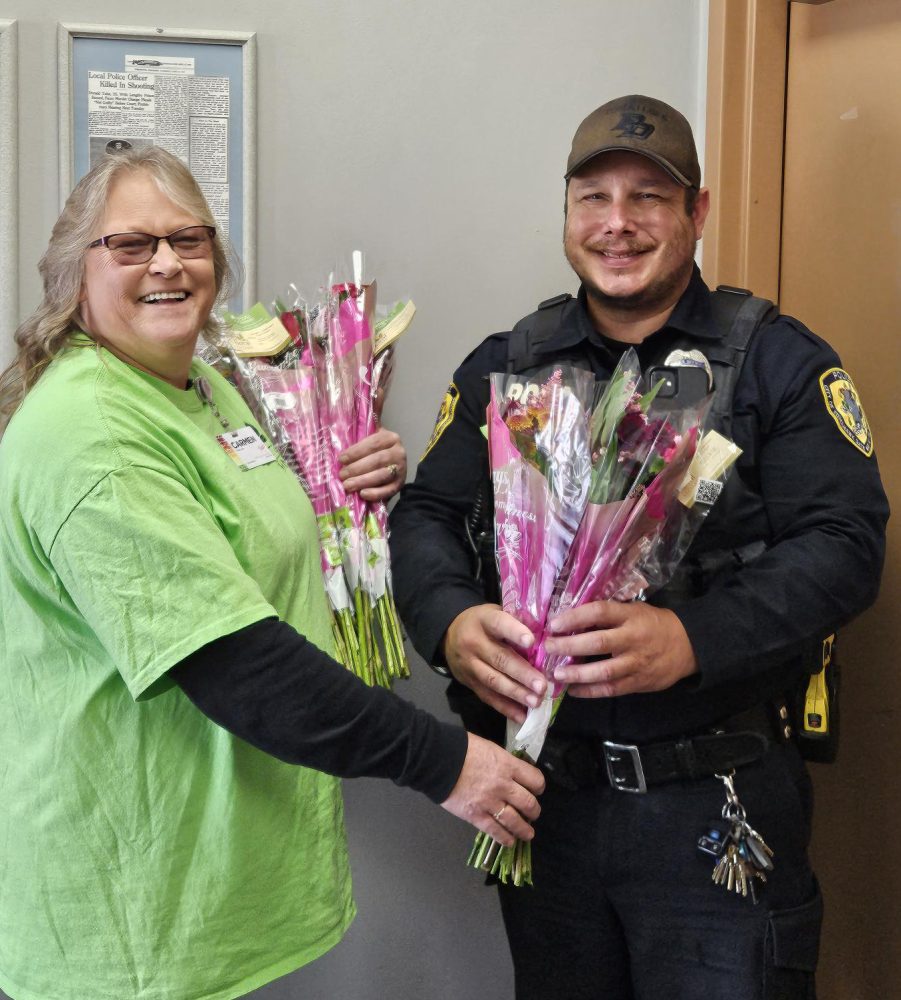 gifting flowers to a security guard