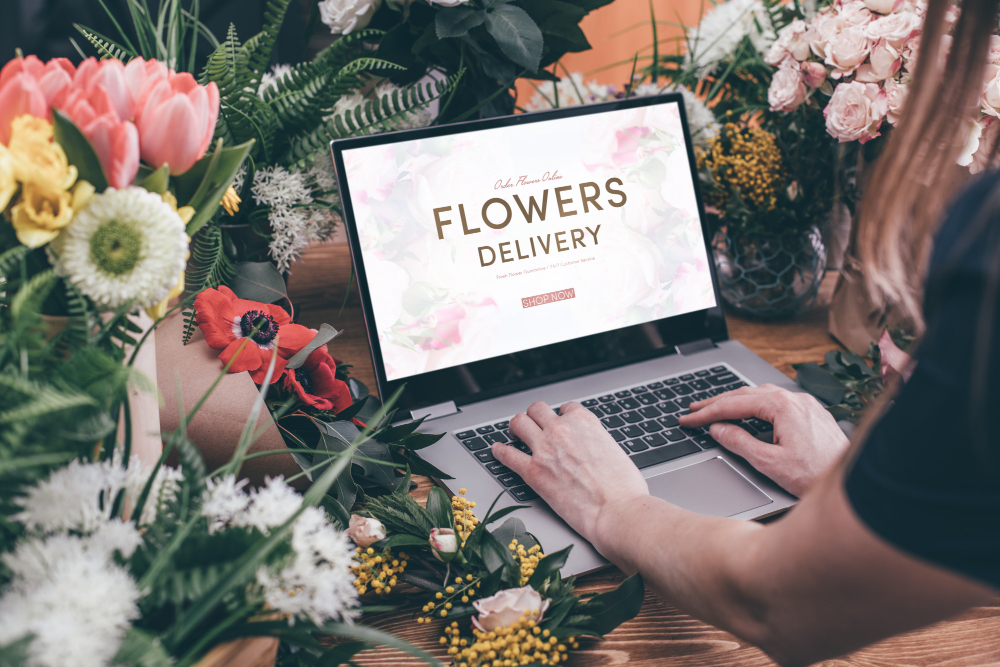 woman using computer  in a flower shop